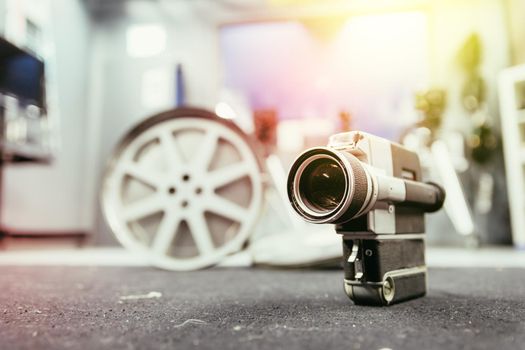 Vintage old movie camera, production studio in the blurry background