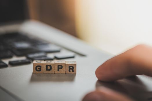 GDPR: Wooden cubes with letters “GDPR” lying on a laptop. General Data Protection Regulation