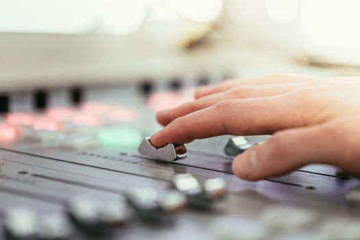 Moderator and soundboard in radio broadcasting studio