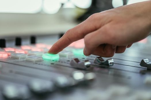 Moderator and soundboard in radio broadcasting studio
