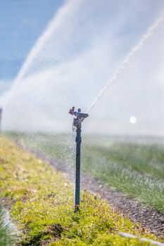 Irrigation plant on an agriculture field, summer day, soil