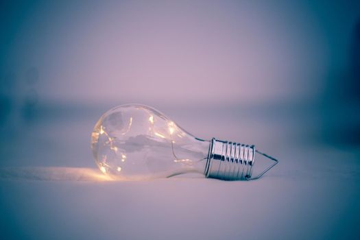 LED light bulb is lying in the bed. Symbol for ideas and innovation.