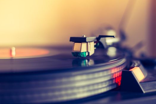 Close up picture of a record player, playing a record. Sunbeam.