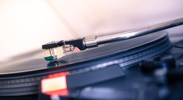 Close up picture of a record player, playing a record