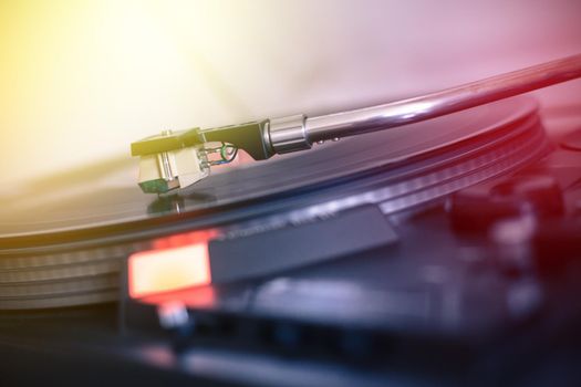 Close up picture of a record player, playing a record. Sunbeam.