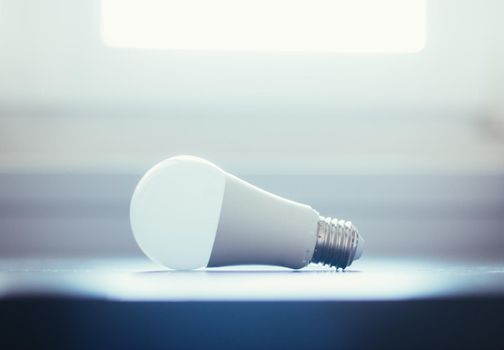 White light bulb lying on a desk, concept for ideas