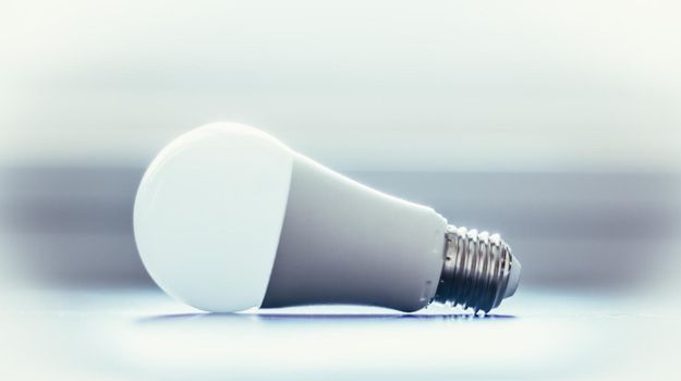 White light bulb lying on a desk, concept for ideas