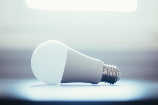 White light bulb lying on a desk, concept for ideas