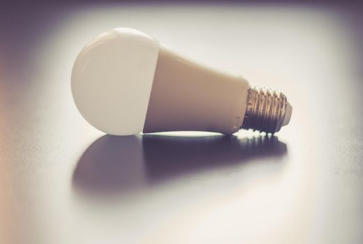 White light bulb lying on a desk, concept for ideas