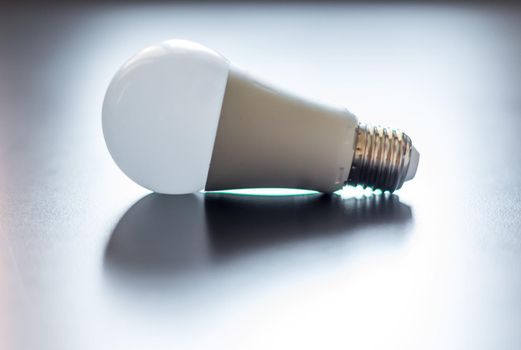 White light bulb lying on a desk, concept for ideas