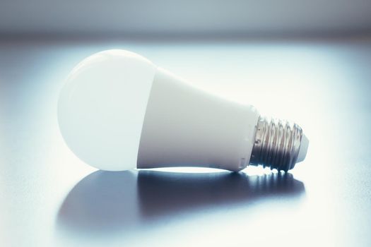 White light bulb lying on a desk, concept for ideas