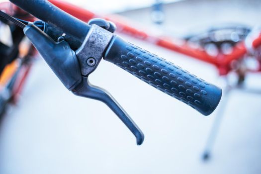 Closeup picture of a bicycle handlebar and breaks, bike repair, blurred background