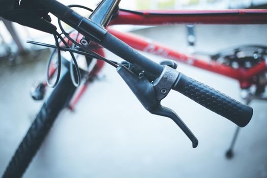 Closeup picture of a bicycle handlebar and breaks, bike repair, blurred background