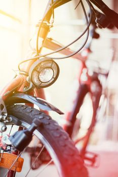 Front picture of a city bike, head lamp and blurry background