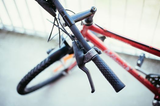 Closeup picture of a bicycle handlebar and breaks, bike repair, blurred background