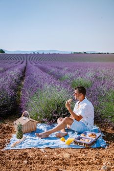 Provence, Lavender field France, Valensole Plateau, colorful field of Lavender Valensole Plateau, Provence, Southern France. Lavender field. Europe. Couple men and woman on vacation at the provence lavender fields,