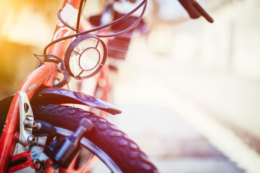Front picture of a city bike, head lamp and blurry background