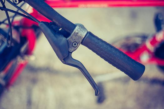 Closeup picture of a bicycle handlebar and breaks, bike repair, blurred background