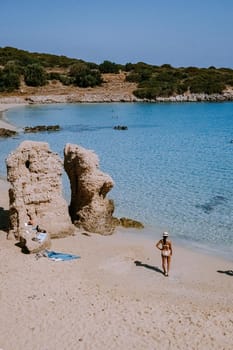 Tropical beach of Voulisma beach, Istron, Crete, Greece ,Most beautiful beaches of Crete island -Istron bay near Agios Nikolaos young asian woman mid age on vacation Greece Crete