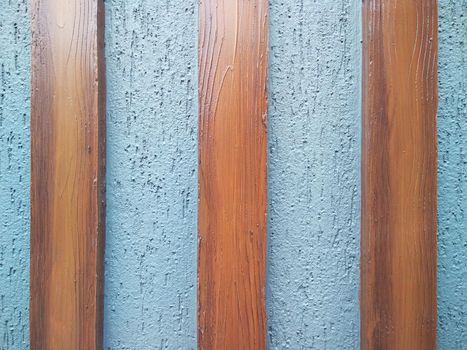 wooden plank on cement plaster surface for decoration purpose.