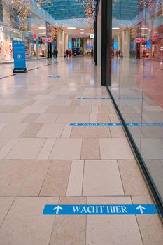 Utrecht, The Netherlands January 2021 - empty shopping mall during the lockdown in the Netherlands Hoog Catherijne shopping mall in the center of town during the covid pandemic with social distance signs on the floor. Holland