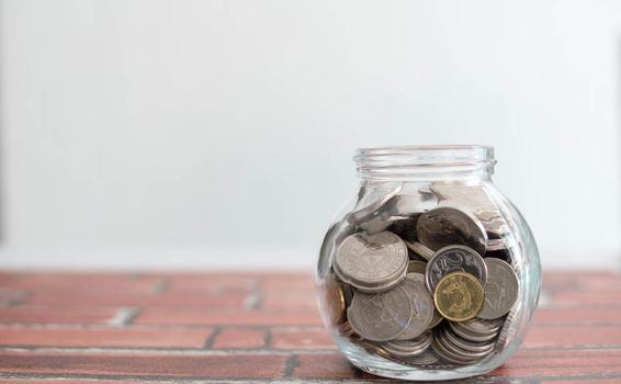 Saving money for a good future for business and for family. Coins inside a jar. Money and coins inside a jar