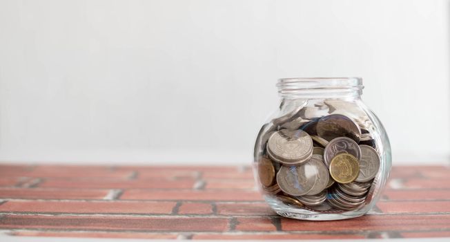 Saving money for a good future for business and for family. Coins inside a jar. Money and coins inside a jar