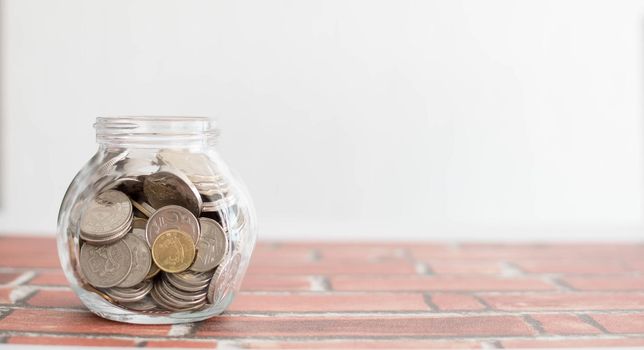 Saving money for a good future for business and for family. Coins inside a jar. Money and coins inside a jar