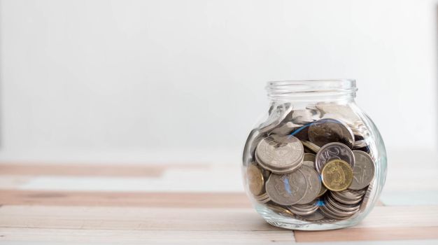 Saving money for a good future for business and for family. Coins inside a jar. Money and coins inside a jar