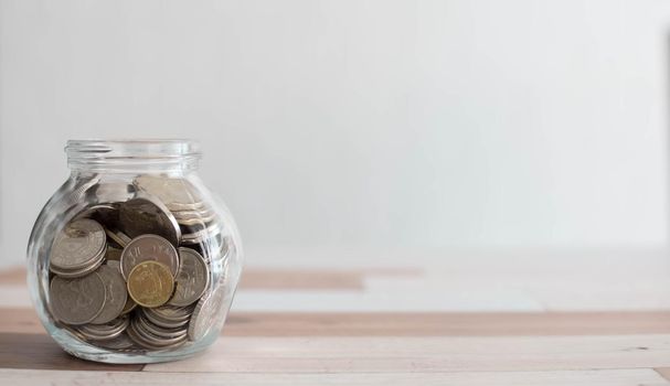 Saving money for a good future for business and for family. Coins inside a jar. Money and coins inside a jar