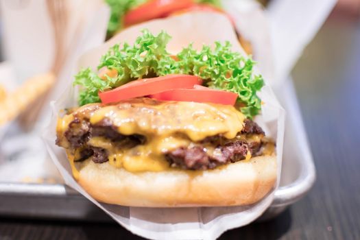 Shake shack burger yummy beef burger with melting cheese and vegetables.