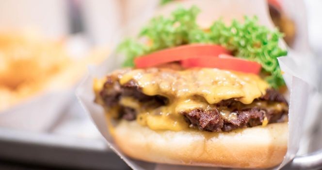 Shake shack burger yummy beef burger with melting cheese and vegetables.