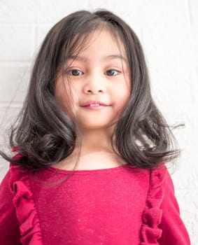 A Fashion model and beauty look. Stylish girl with pretty face on grey background. Hairdresser, skincare, casual style. Beauty and kid fashion with healthy hair. Little girl with long hair.