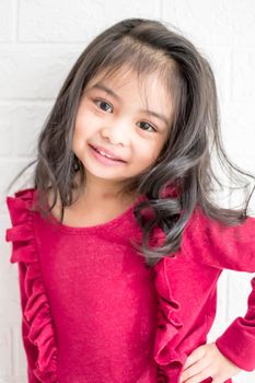 A Fashion model and beauty look. Stylish girl with pretty face on grey background. Hairdresser, skincare, casual style. Beauty and kid fashion with healthy hair. Little girl with long hair.