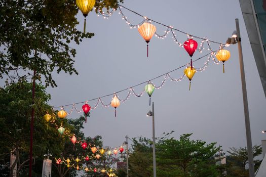 Paper lanterns on the streets in Asia. Colorful lanterns hanging on streets during the Chinese lantern festival.