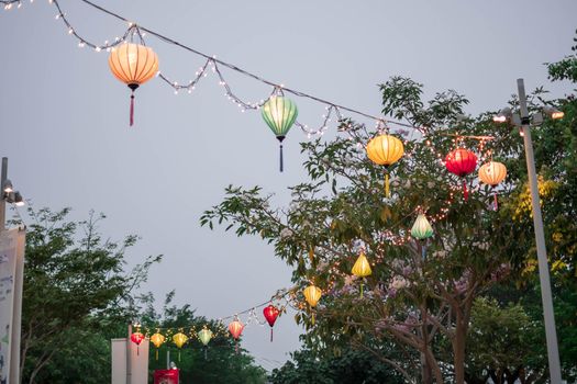 Paper lanterns on the streets in Asia. Colorful lanterns hanging on streets during the Chinese lantern festival.