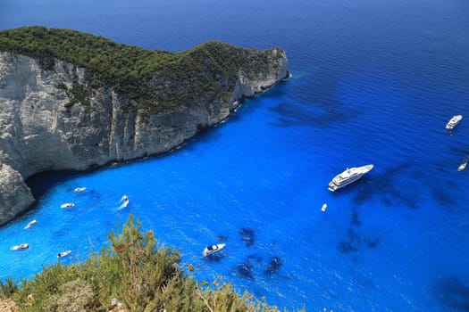 Aerial view of blue azure coast with turquoise water, white yachts . Summer travel in Greece, the best world beach