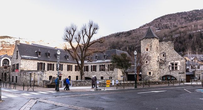 Saint Lary Soulan, France - December 26, 2020: architectural detail of the town hall in the historic city center where tourists walk on a winter evening