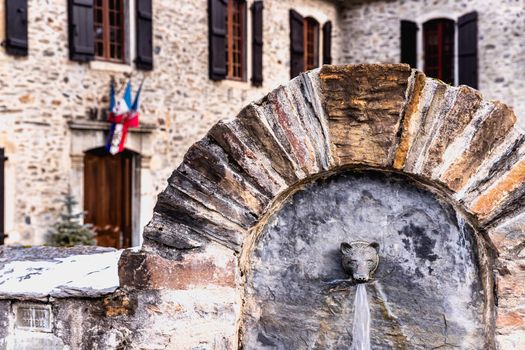 Saint Lary Soulan, France - December 26, 2020: architectural detail of the town hall in the historic city center where tourists walk on a winter evening