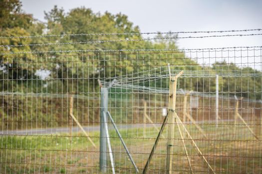 double barbed wire mesh protecting military installations or a border - concept