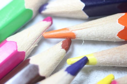 Close-up view of bright colored multicolor pencils on black background