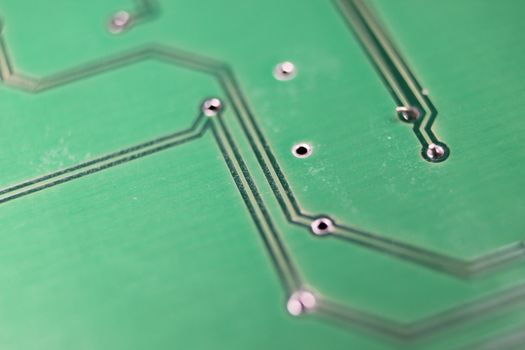 Electronic board with circuit lines and chip. Macro view of green board