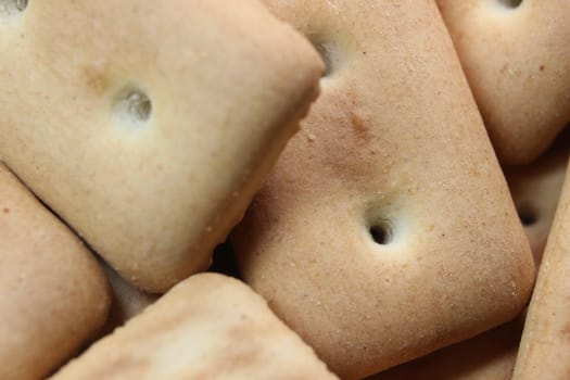 Close up top view of of biscuit cookies. Close up view rectangular biscuits with small pores