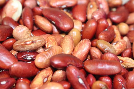 Kidney beans: Closeup view of uncooked red kidney beans. Dark red useful beans background.