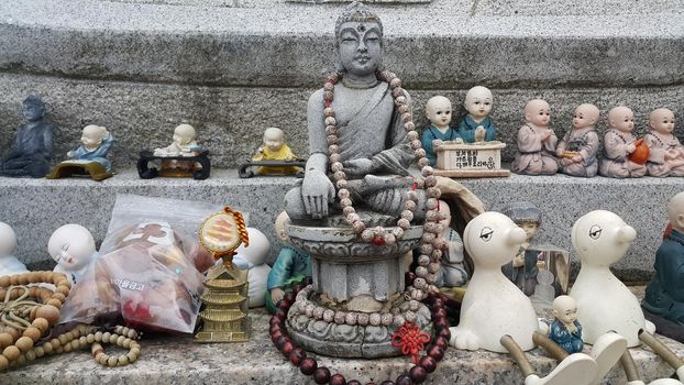 Closeup view of statues of religious monks. Buddha mini statue with beautiful background