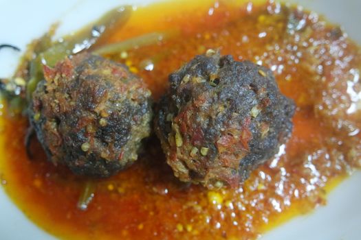 Closeup view with selective focus of meatball dish.Top view of meat balls or meat kofta curry in masala gravy in a ceramic plate.