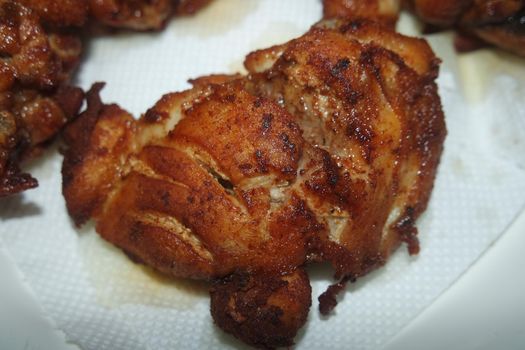 Fried, grilled baked chicken pieces with marinated spices on it. Tasty delicious fried chicken barbecue