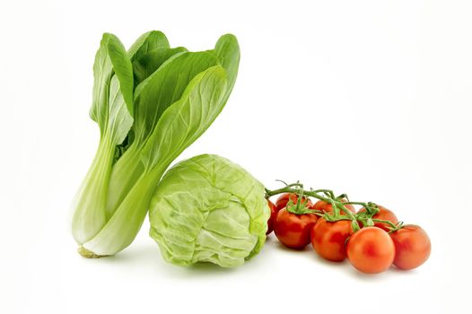 Chinese cabbage and white cabbage and cherry tomato twig isolated on white background
