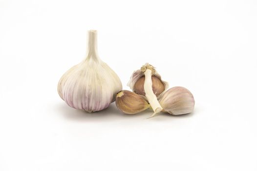 Garlic bulbs and cloves in close-up isolated on white background
