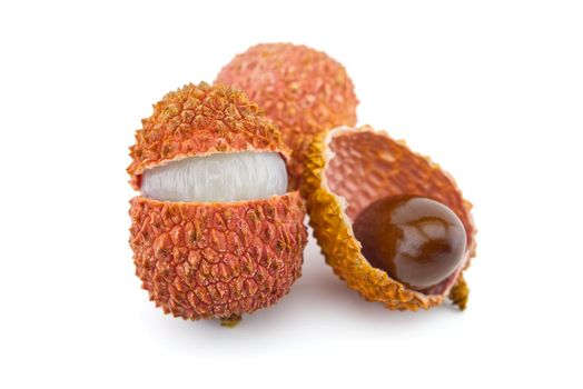 Lychee fruit opened and showing seed isolated on white background